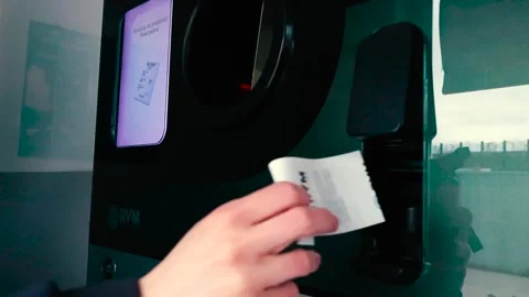 Person Taking a Voucher from a Reverse Vending Machine for Recycling Stock Footage 335131895