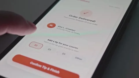 Person tapping screen on smartphone application to confirm online tip payment Stock Footage 341569766