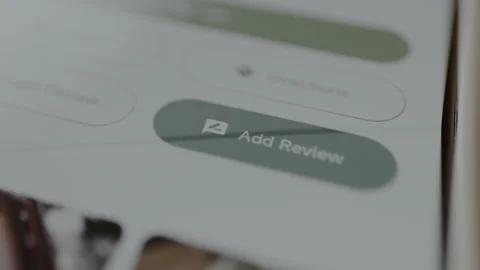 Person taps the button labeled Add Review, product review, online shopping Stock Footage 328809447