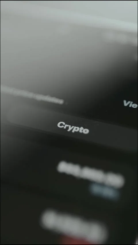 Person taps the digital button labeled Crypto from a trading app interface Stock Footage 330251611