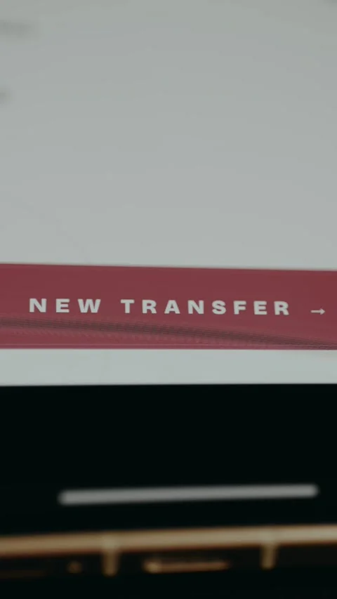 Person taps the digital button labeled New Transfer for a financial transaction Stock Footage 331578756