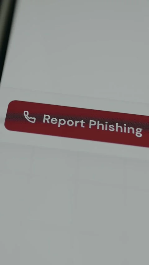 Person taps the digital button labeled Report Phishing Stock Footage 332892185