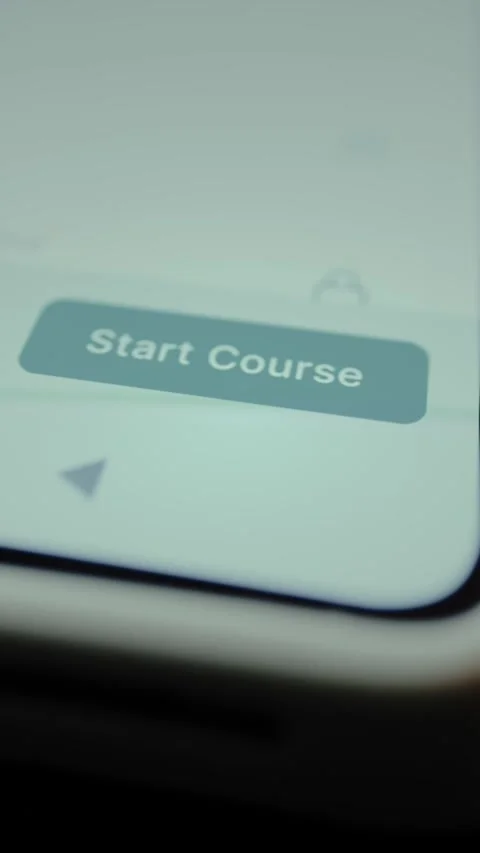 Person taps the digital button Start Course within a learning app interface 库存影片 328356777