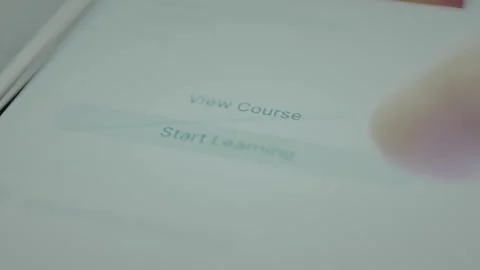 Person taps the option Start Learning within a mobile app interface, lifelong Stock Footage 328355873
