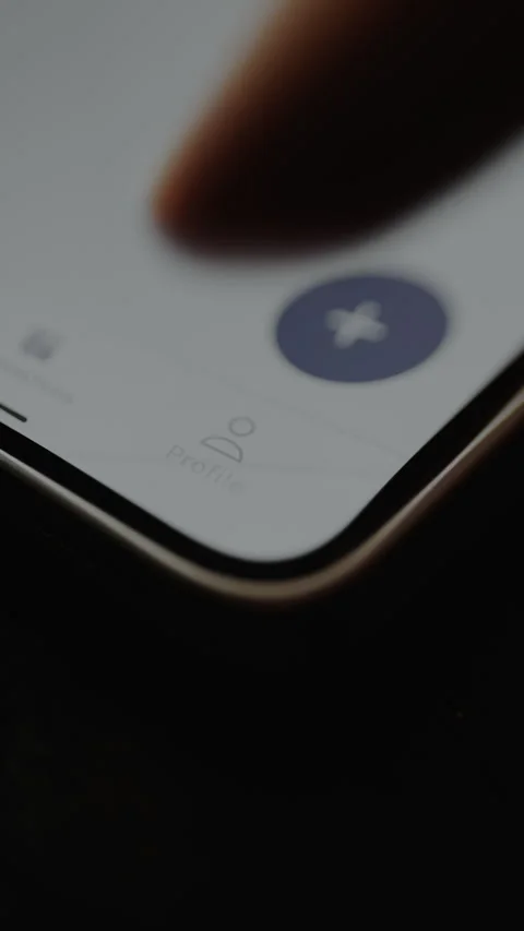 Person taps the Profile tab icon, accessing the account settings Stock Footage 328882434