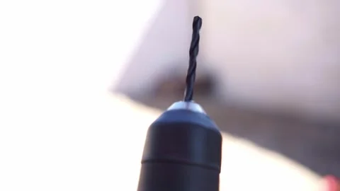 Person testing electric drill machine close up, power tool with metal bit Stock Footage 345293609