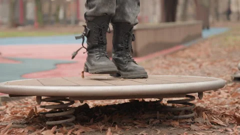 Person tests balance on spring pad. Solitary person examines and challenges Stock Footage 337370424