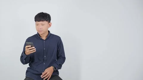 Person Thinking While Looking at Smartphone Stock Footage 344831139