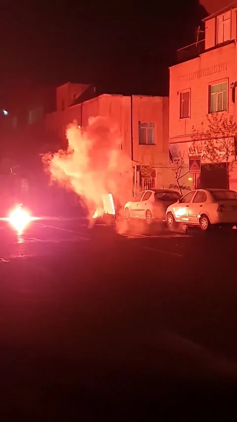Person Throwing Loud Handcrafted Firecracker on Tehran Street at Night Stock Footage 345370110