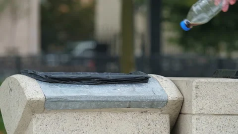 Person throws a plastic bottle into a trash can Video stock 196170112