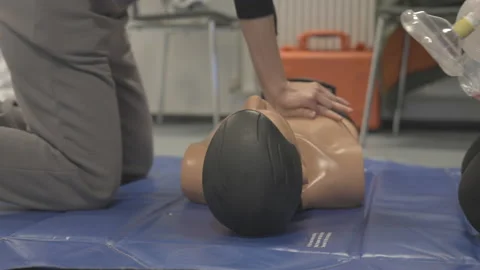 A Person Thrusting A Dummy's Chest To Ventilate Stock Footage 154951956