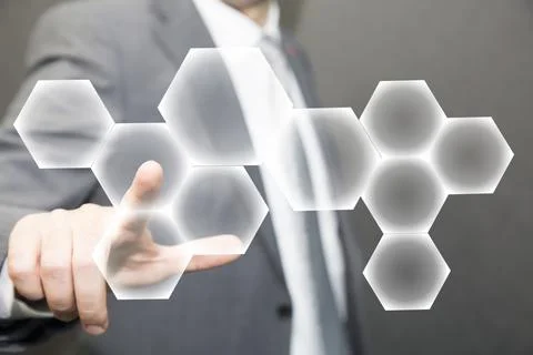 Person touching an hexagonal button on a digital interface. Concept about Stock Photos