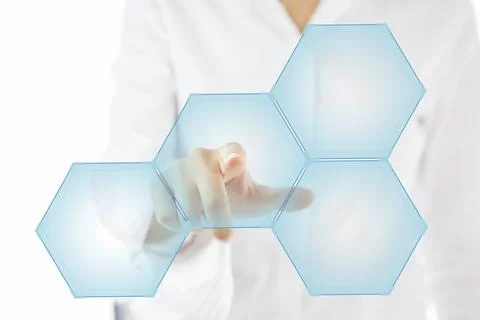 Person touching an hexagonal button on a digital interface Stock Photos