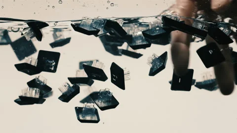 Person touching keys from a keyboard floating in water 스톡 동영상 130309601