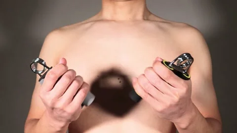 A person training their grip strength with a hand grip. Stock Footage 336661795