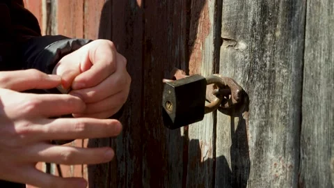 A person tries to open the lock with different keys Stock Footage 181985915