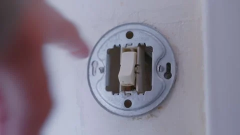 Person Turning Off The Light Switch Before Leaving The House. - closeup Stock Footage 243558619
