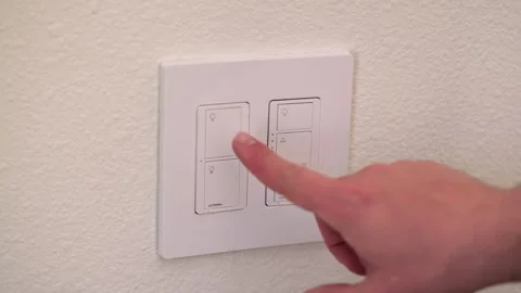 Person turning on a modern light switch Video stock 329068012
