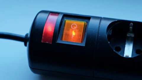 Person turns on and off the button on the electrical extension cord. Stock Footage 121807264
