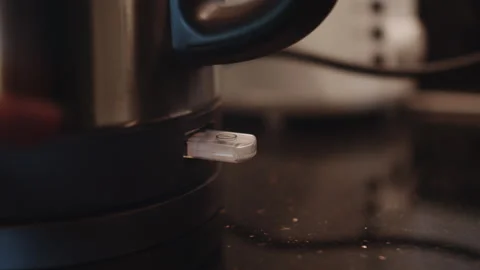 Person turns on the electric kettle. Button for turning on the electric kettle Stock Footage 242117500