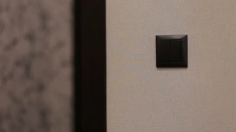 A person turns off the light when leaving the room Stock Footage 112874752
