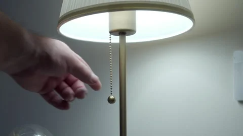 Person Turns On Table Lamp with Pull Chain, Loud Metallic Click Sound Stock Footage 321204577