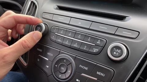 Person turns up the volume using control buttons of the car stereo. Adding sound Stock Footage 250422477