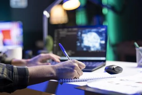 Person typing and writing code at home Stock Photos