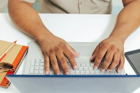 Person typing on computer at desk Stock Photos