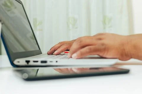 Person typing on computer at desk Stock Photos