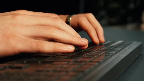 Person typing on computer keyboard, fast typing hands in office environment Stock Footage 321322071
