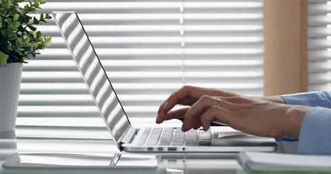 Person typing on computer keyboard in modern office, close-up of hands Vídeos de archivo 119725089