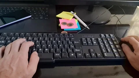 Person typing on a computer keyboard. Office worker using PC for remote business Stock Footage 340241508