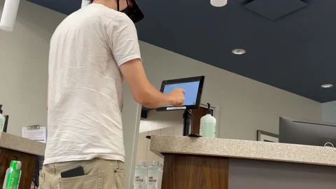 Person typing on emergency room computer check in Stock Footage 158863080