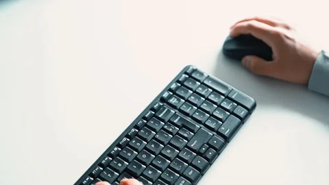 Person typing on the keyboard and using the mouse. Teleworking and distance e Stock Footage 133233811