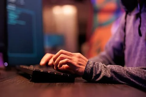 Person typing on a keyboard with code on screen Stock Photos