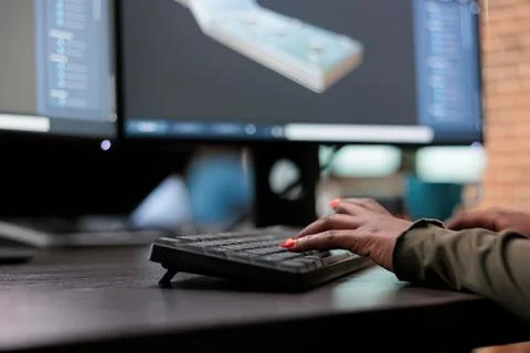 Person typing on keyboard with coding screen Stock Photos