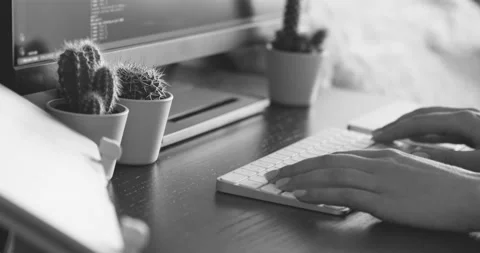 Person typing on a keyboard computer in black and white Stock Footage 193393034