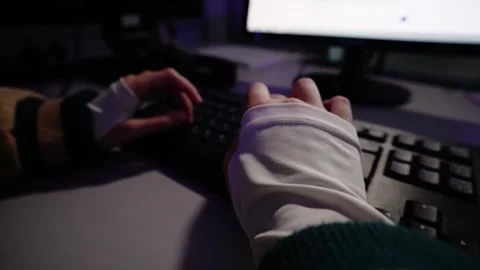 Person typing on keyboard at computer desk at night Stock-Footage 348029544