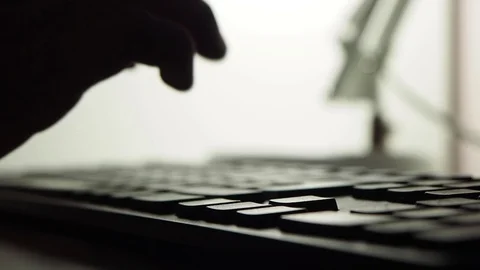 A person is typing on the keyboard in the evening or at night, close-up Stock Footage 128441786