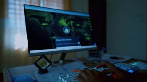 Person typing on a keyboard in front of a computer screen displaying a digi.. Stock Footage 315981986