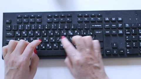 Person is typing on a keyboard with the letters A, B, C, D, E, F, G, H, I, J Stock Footage 330104159