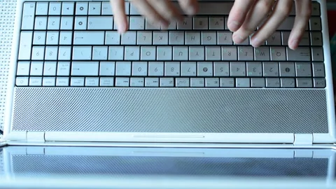 The person is typing on the keyboard of the notebook Stock-Footage 89304701