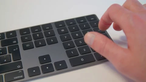 Person typing on keyboard on numeric pad Stock Footage 144282388