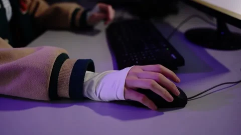 Person typing on keyboard using computer mouse at desk 動画素材 348029462
