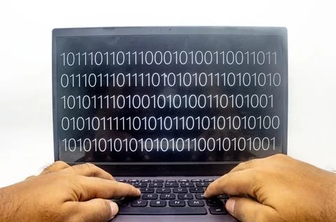 A person typing on a laptop with binary code displayed on the screen. Perfe.. 写真素材