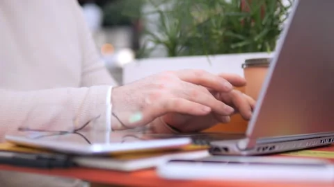 Person is typing on a laptop computer with a cup of coffee next to them Stock Footage 308872049