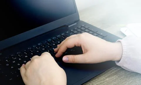 Person Typing on a Laptop Computer Stock Photos