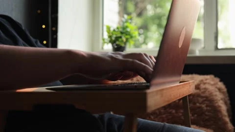 Person typing on a laptop computer on a tray table indoors Stock Footage 340264646