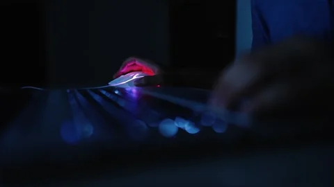 Person typing on laptop in dim light Stock Footage 320724730